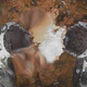 The two-pronged robotic hand picking up radioactive debris at the bottom of reactor No. 2.